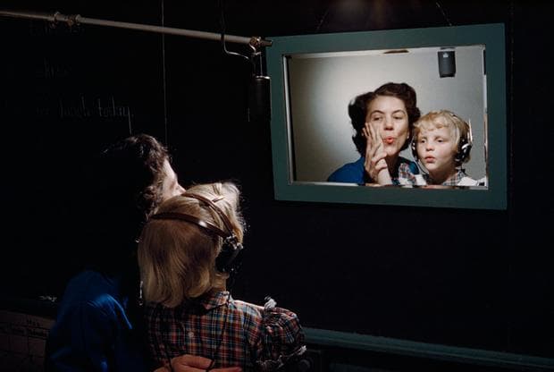 A teacher and a deaf student practice making sounds in front of mirror at the Clarke School for the Deaf in Massachusetts, March 1955. (Photograph by Willard Culver, National Geographic)