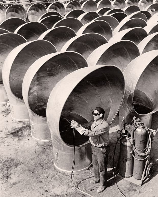 A welder works on cowls for liberty ships in California, 1942. (Photograph by Acme News Pictures, Inc.)
