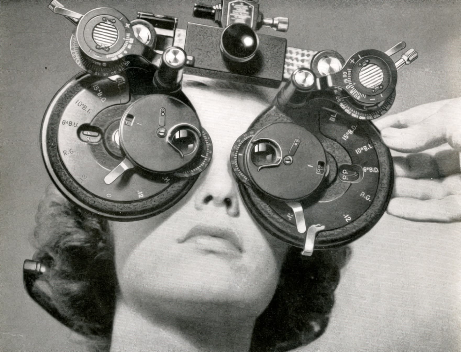 Woman looks through a phoropter in 1945.