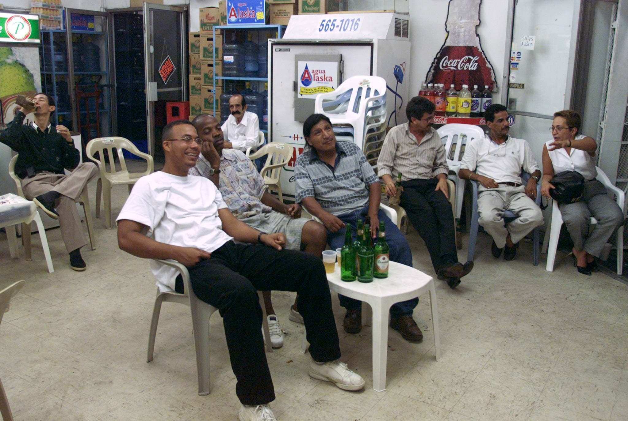 Men sit watching a game in a cafe