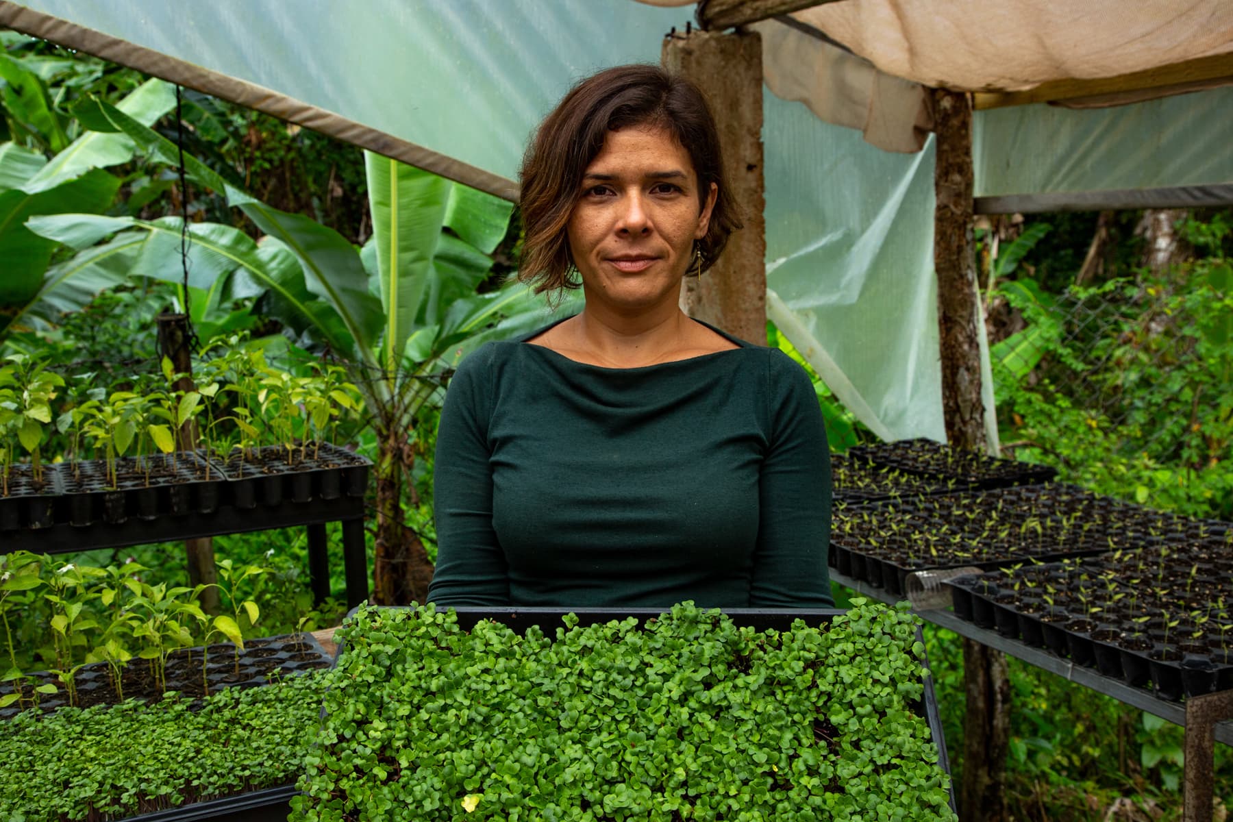 Rivera is shown wearing a green shirt and holding a tray of greens.