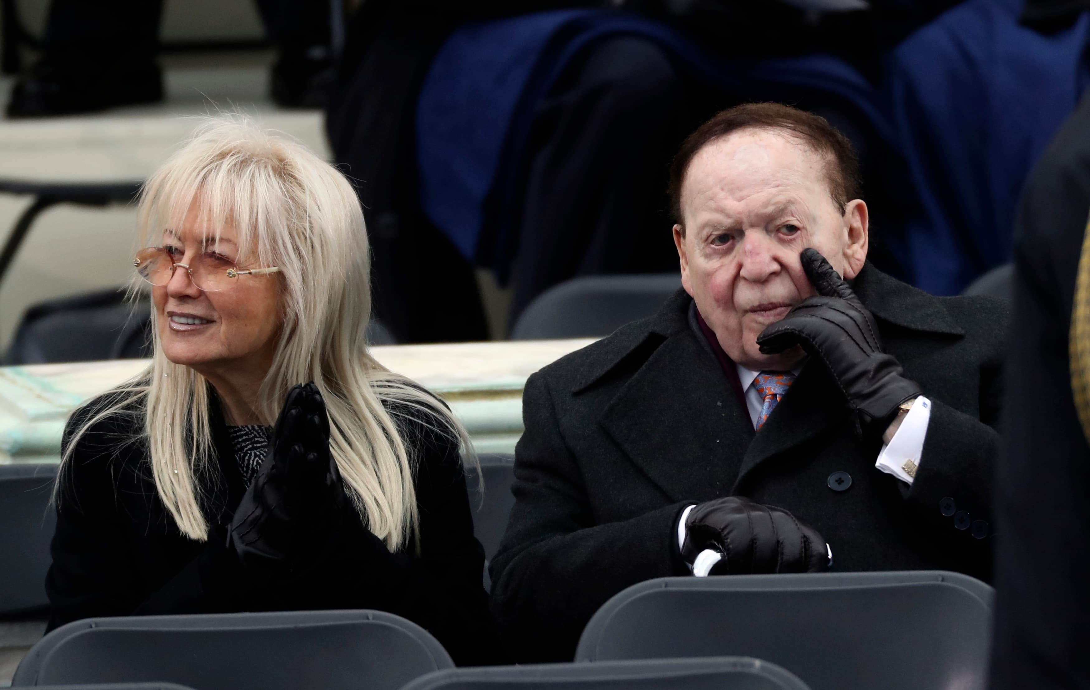 A woman and a man sit outside