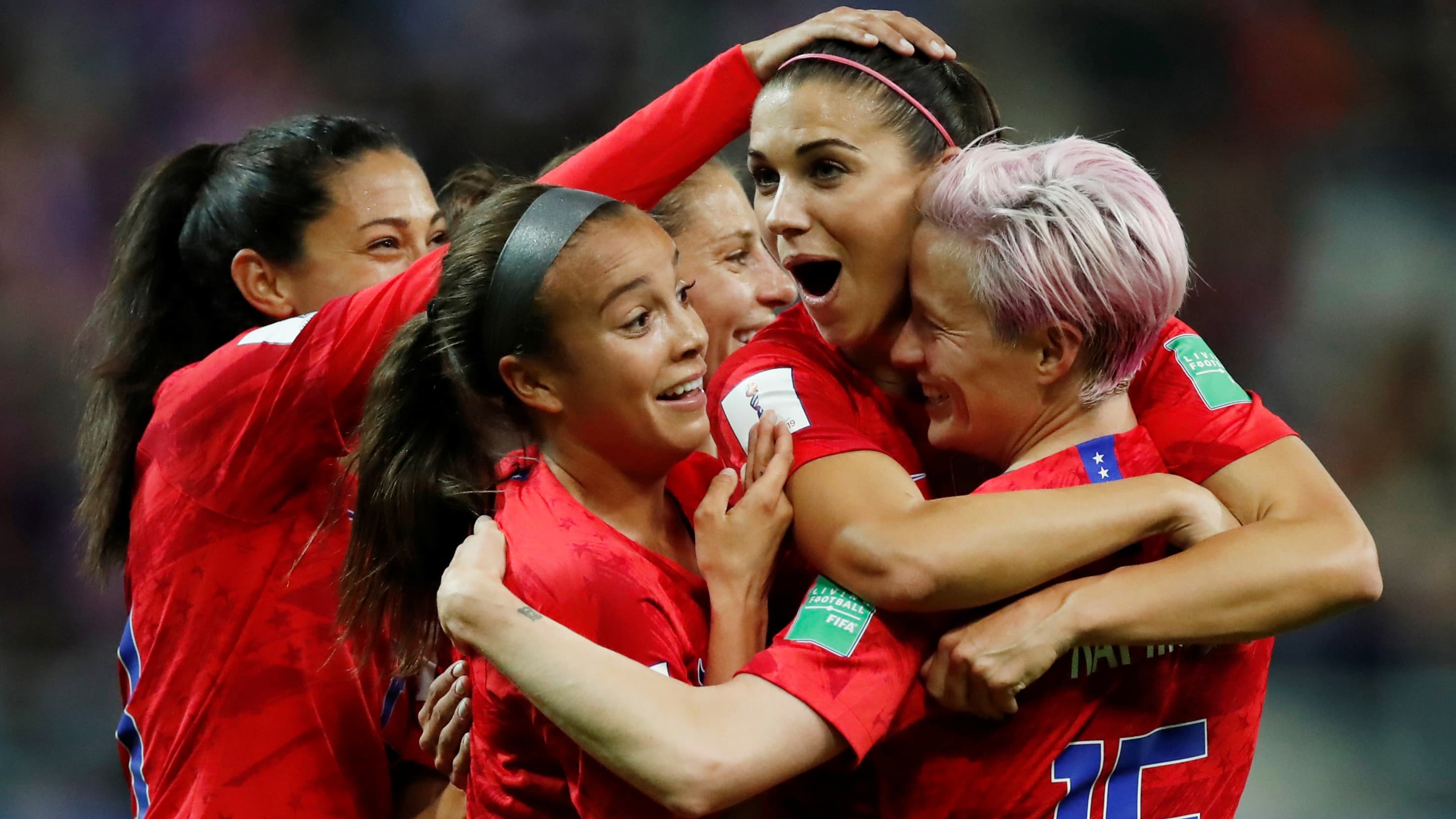 Alex Morgan of the US celebrates scoring their twelfth goal with Megan Rapinoe and teammates.