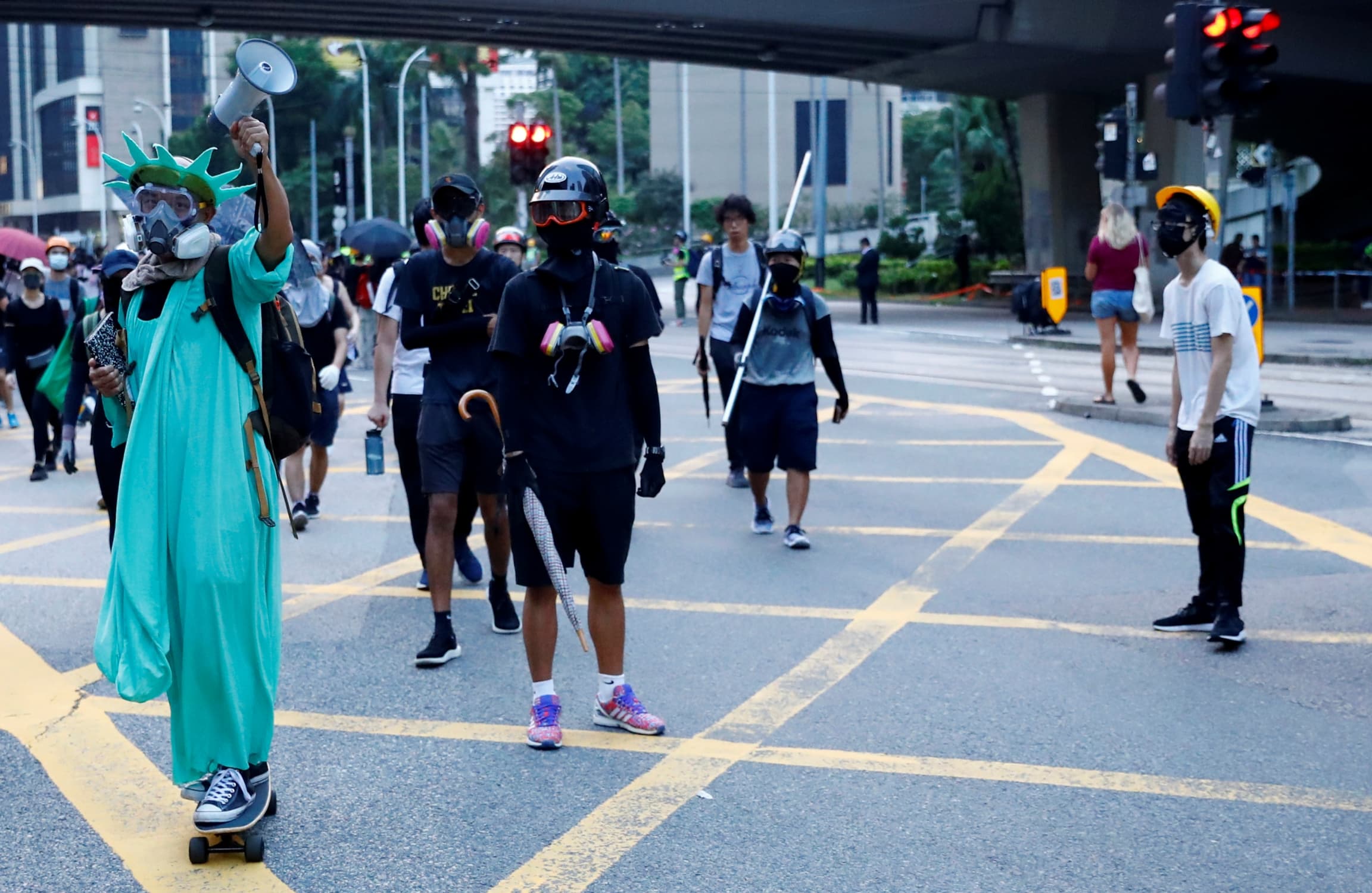 A protestor dressed as the Statue of Liberty attends a protest in Central, Hong Kong,