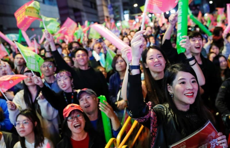 Supporters of Taiwan President Tsai Ing-wen react during a rally outside the Democratic Progressive Party (DPP) headquarters in Taipei, Taiwan, on January 11, 2020.