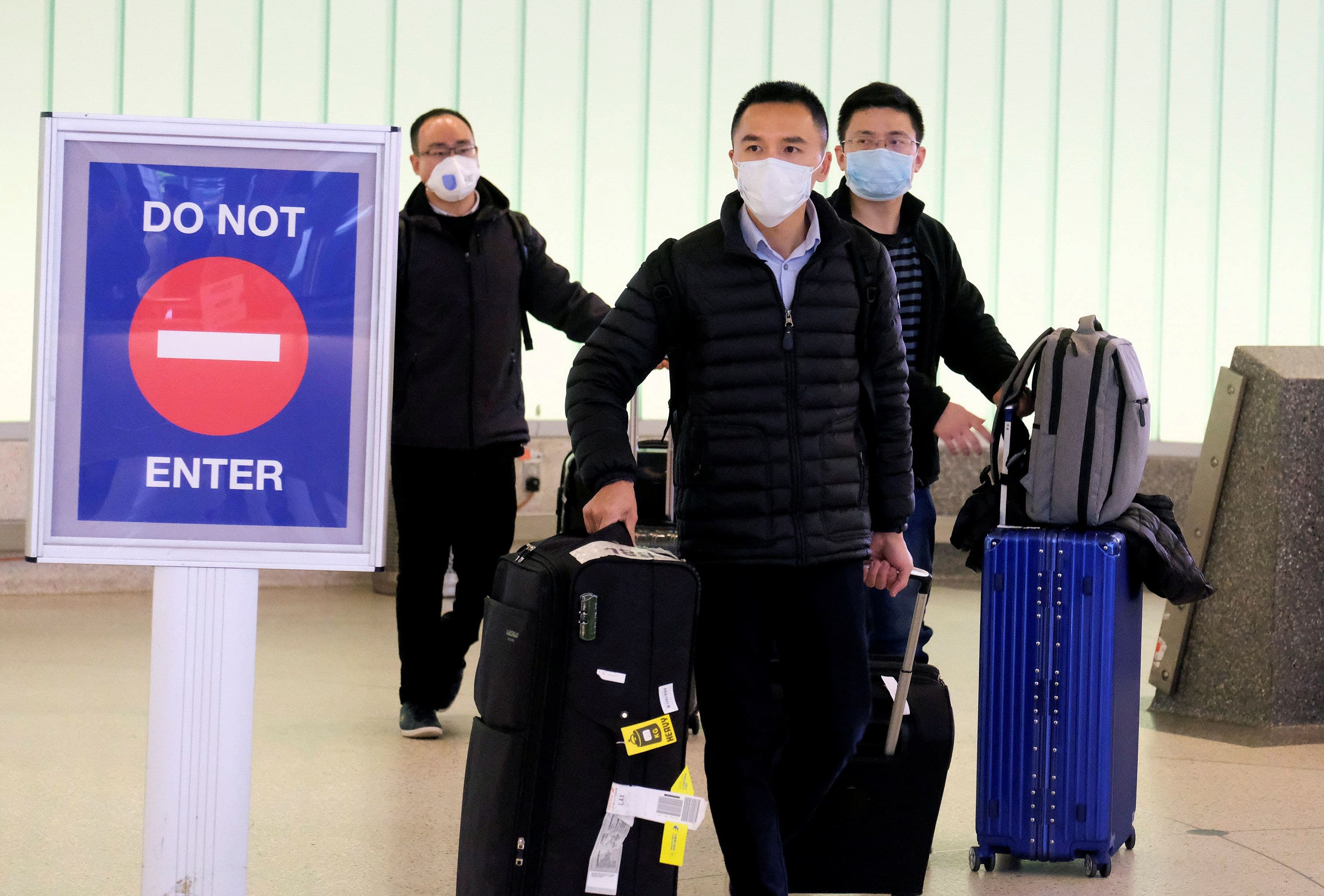Passengers arrive at LAX from Shanghai, China, after a positive case of the coronavirus was announced in the Orange County suburb of Los Angeles, Jan. 26, 2020.