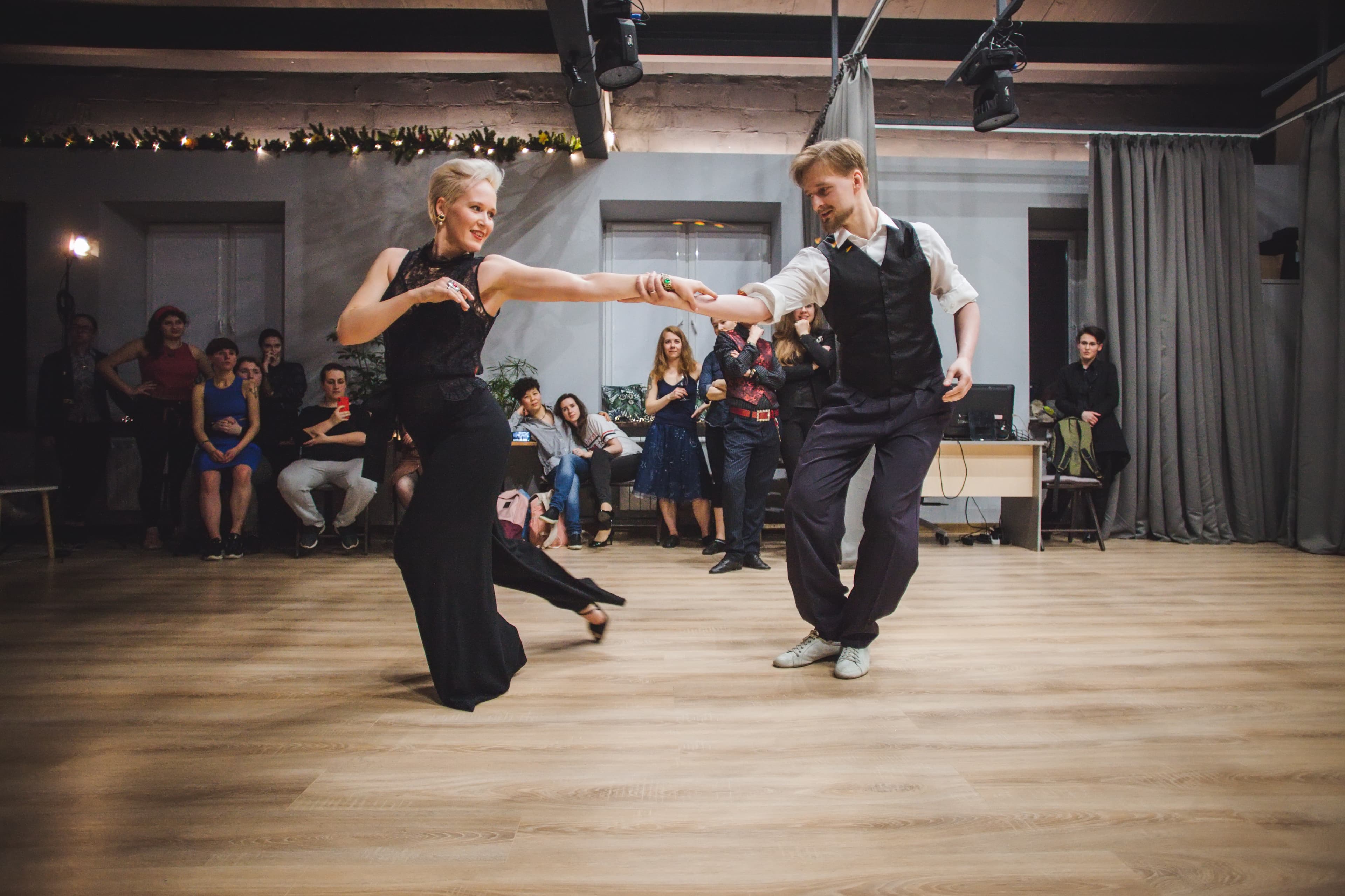 Two people dance at a studio together