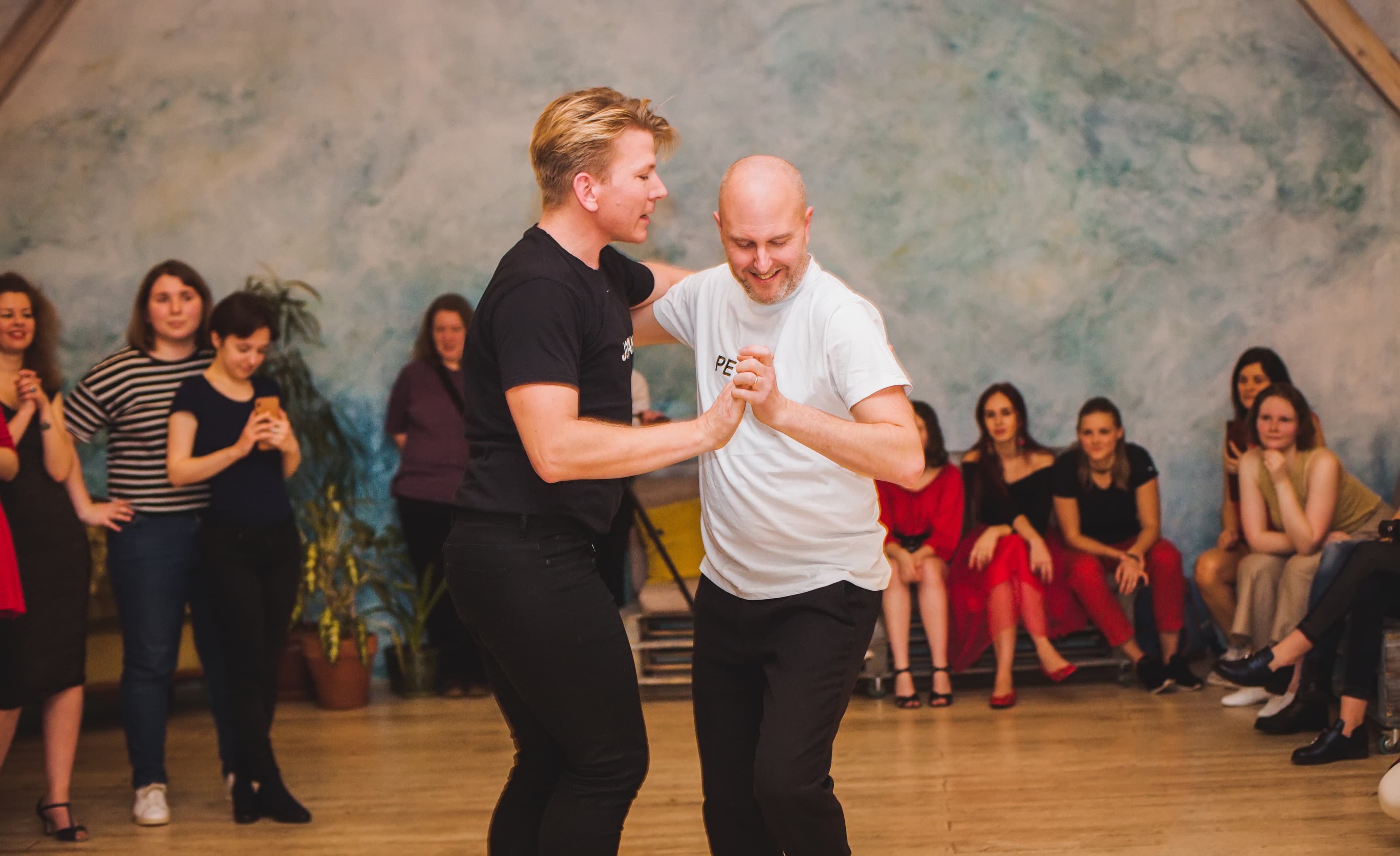 A salsa instructor dances with a student.