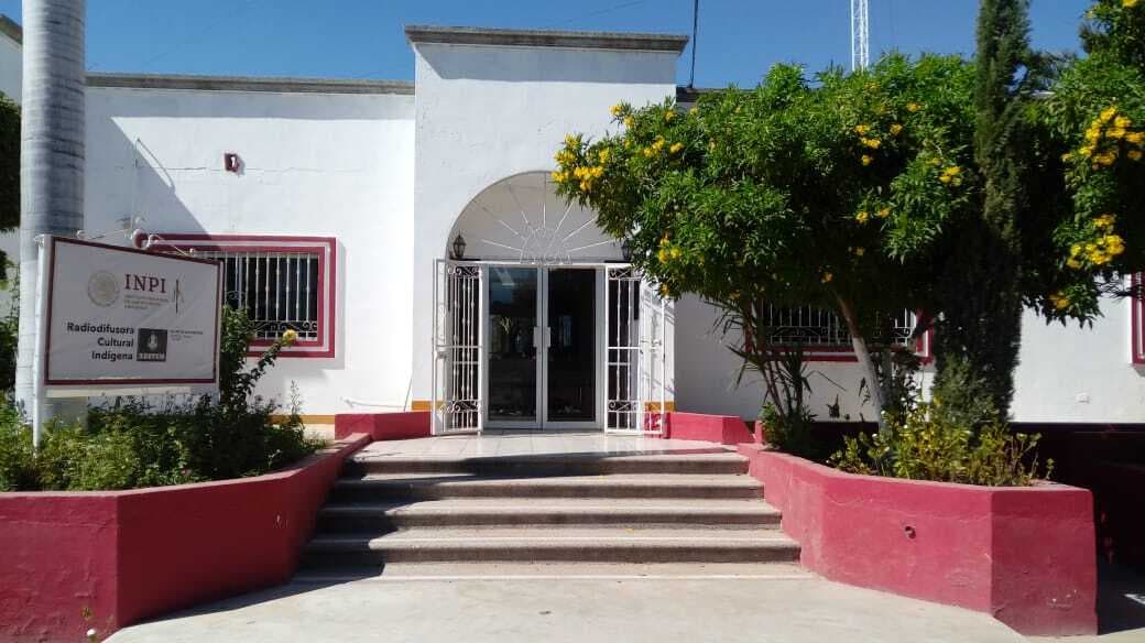 A white building with sign.