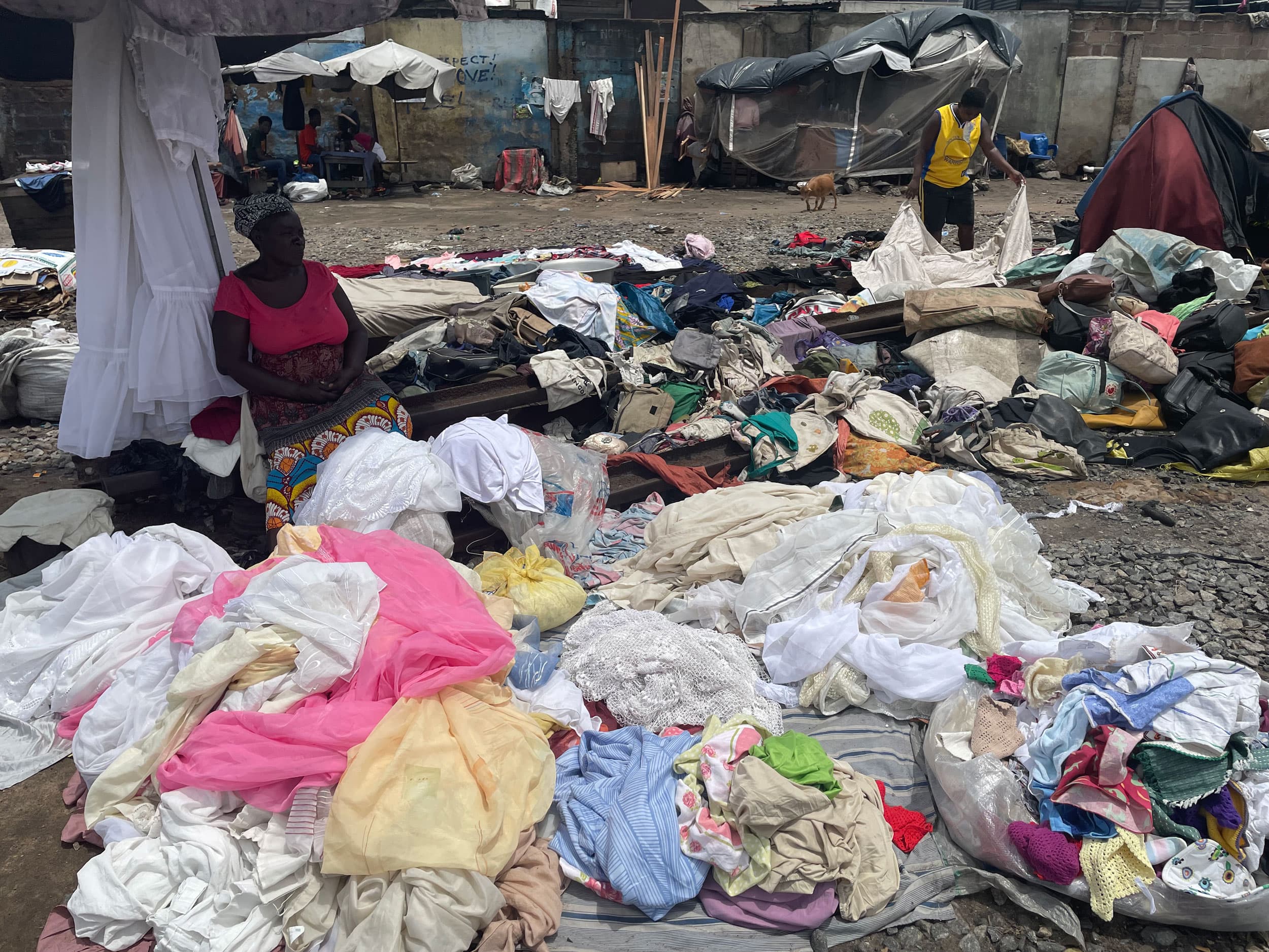 Traders pay middlemen between $20 and $400 to acquire bales of used clothing to resell.
