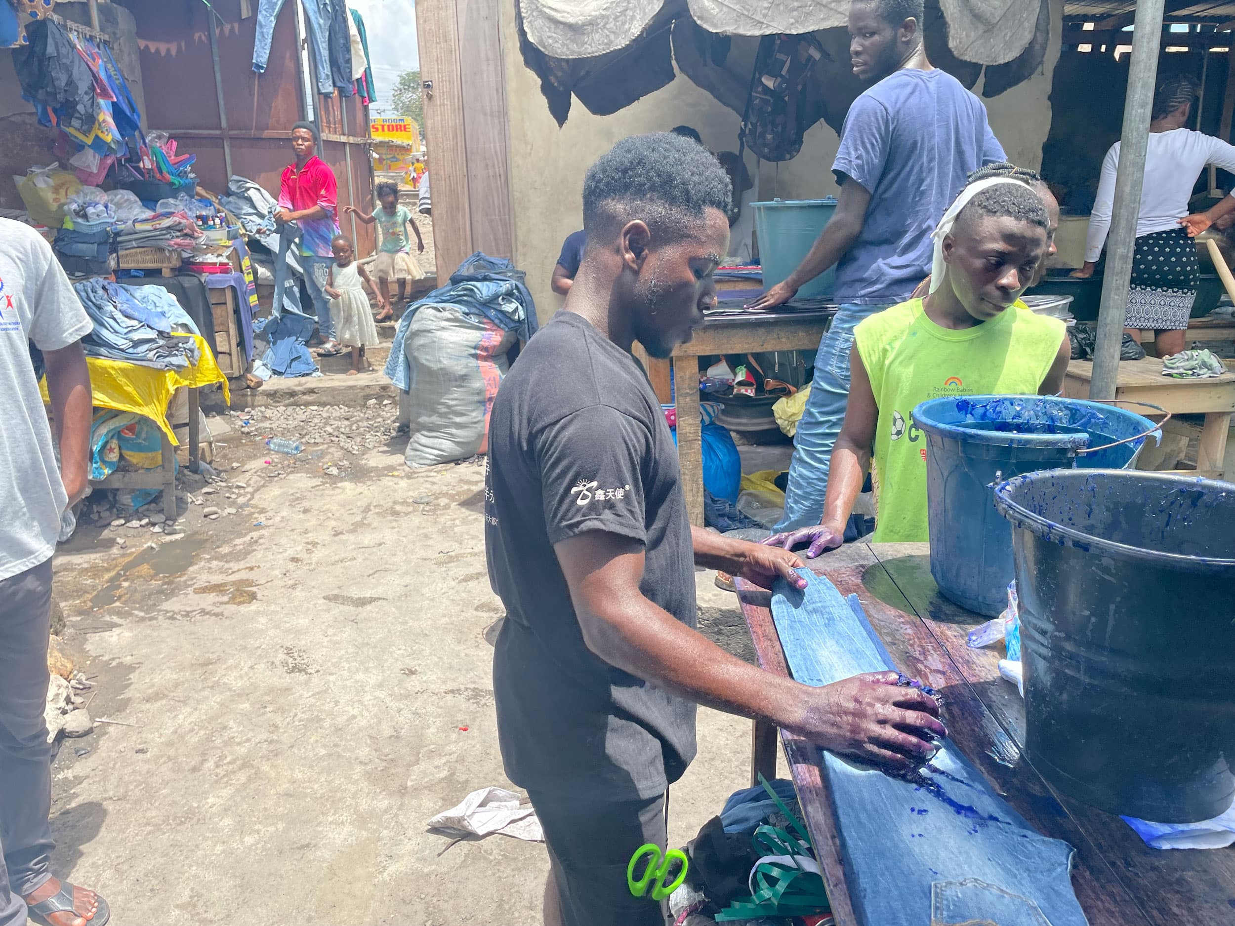 Daniel Frimpong dyes tons of secondhand jeans at Kantamanto market.