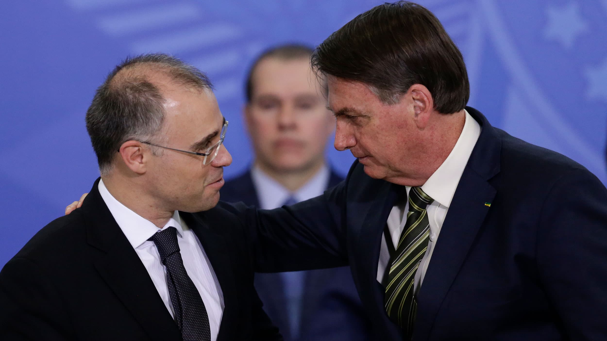 Brazil's President Jair Bolsonaro, right, greets his new Justice Minister Andre Mendonça during his swearing-in ceremony at the Planalto presidential palace, in Brasilia, Brazil, Wednesday, April 29, 2020.