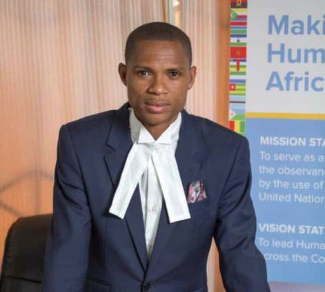 Francis-Xavier Sosu wears a suit with a white tie.