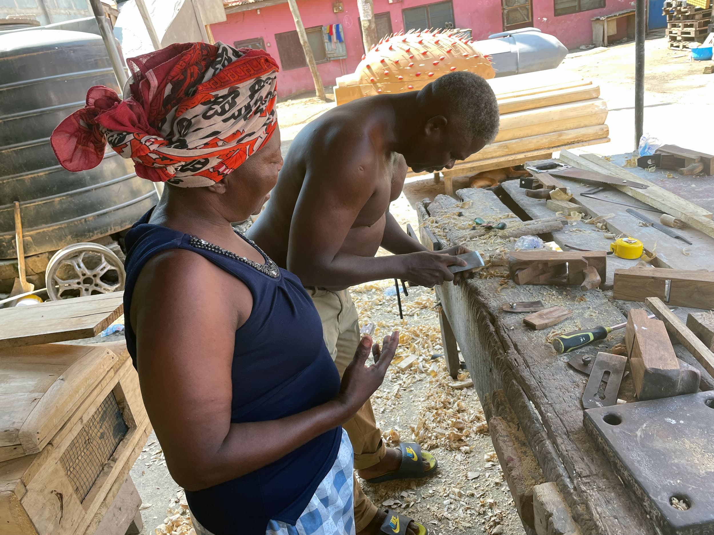 Felicia Okai makes an order at the Kane Kwei fantasy coffin carpentry shop.