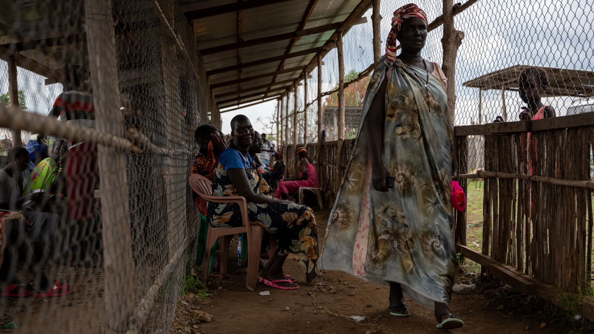 People line up at a camp for internally displaced people to receive food.
