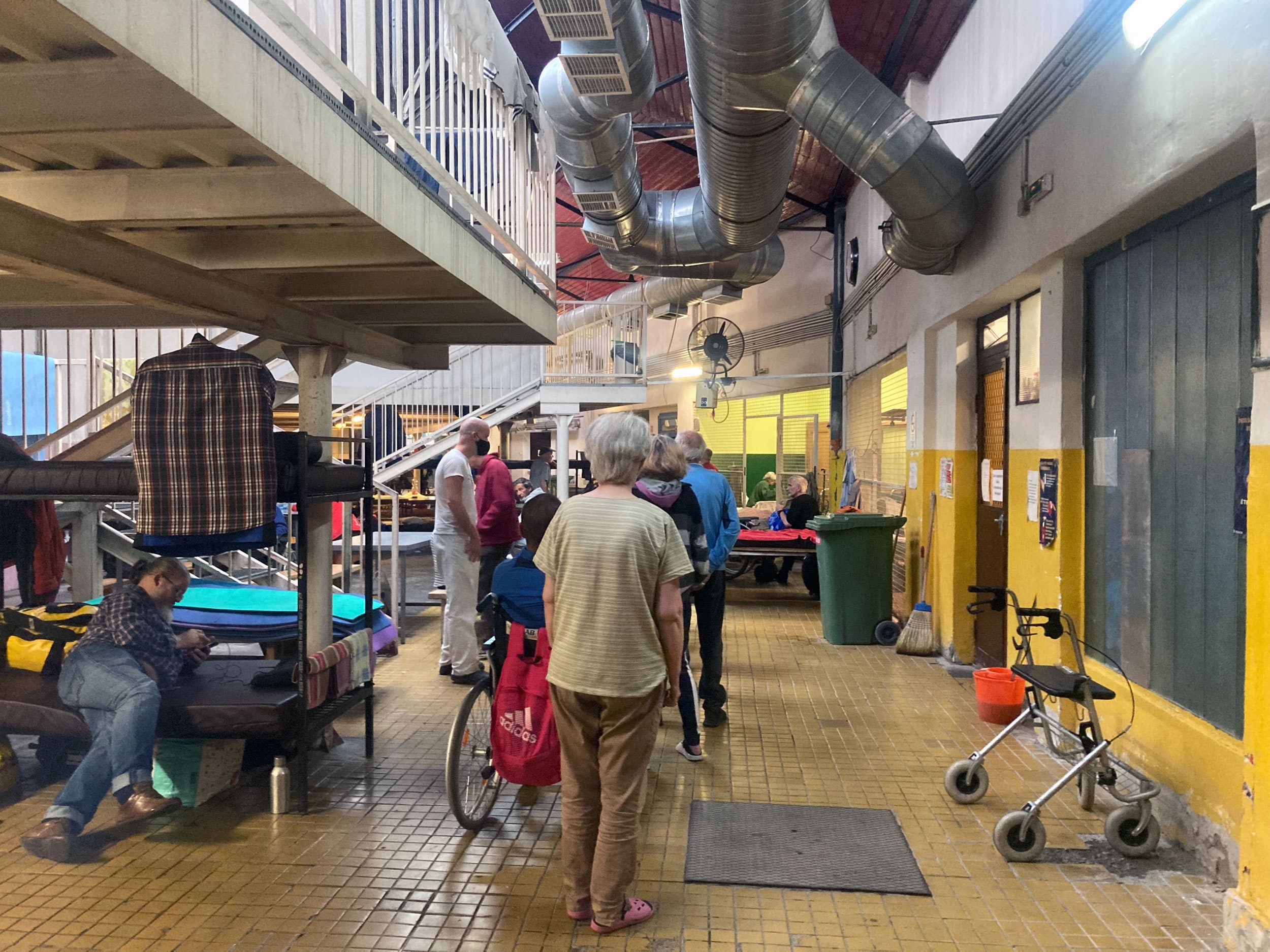 People line up for a hot meal at one of the homeless shelters run by Pastor Ivanyi's church.
