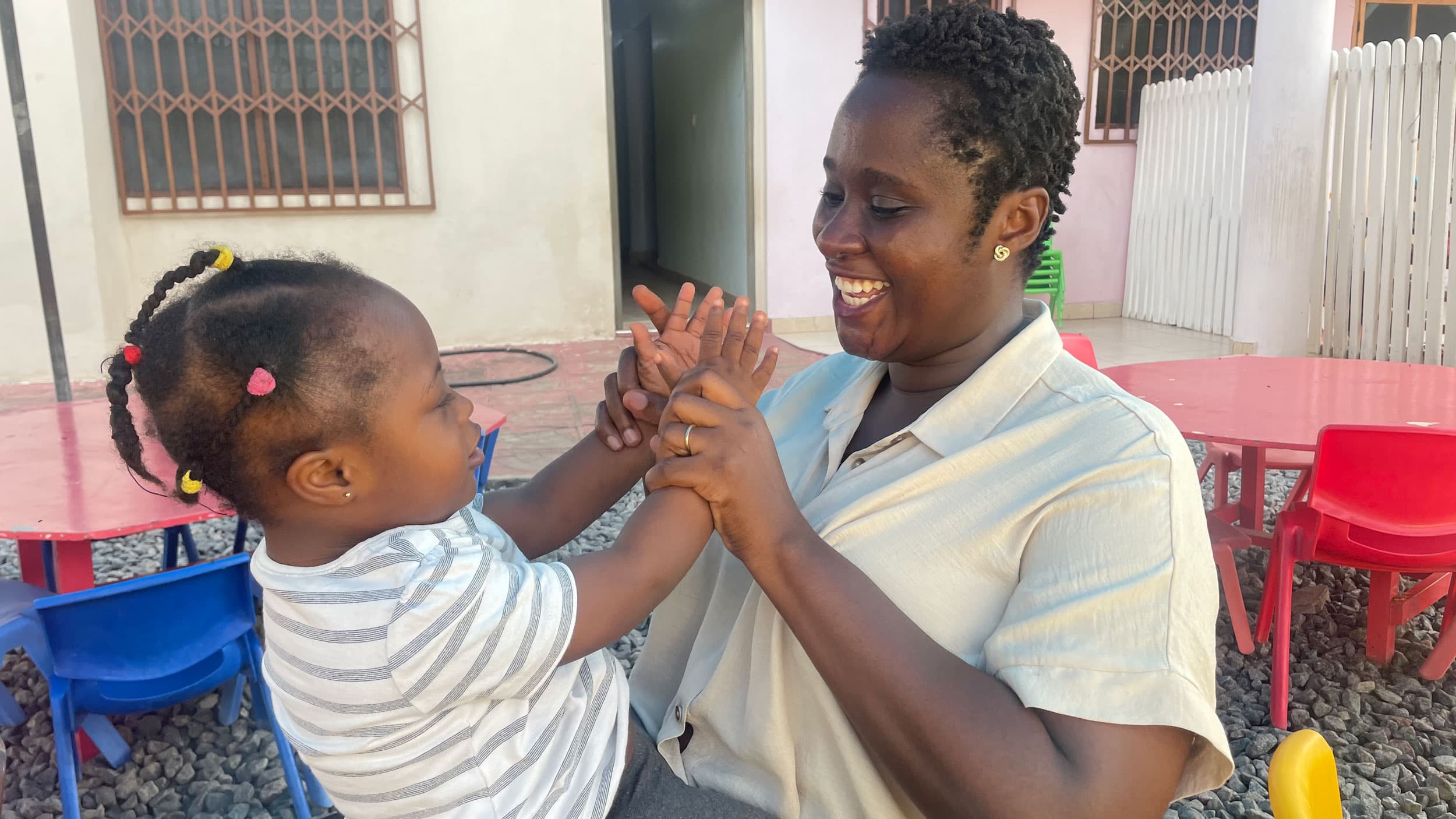 Instructor Akua Amoako Yeboah with a child at the early intervention center.
