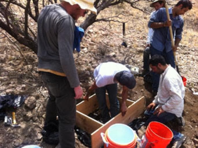 Man standing over archaeology site